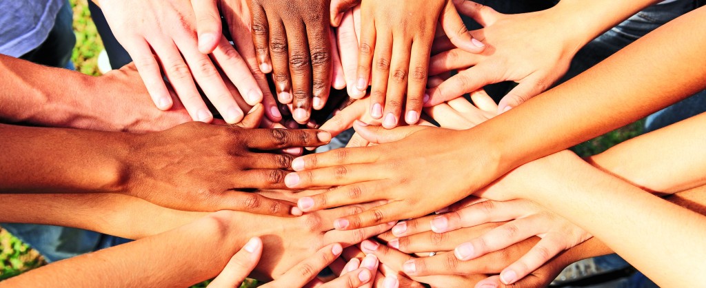 many hands together: group of people joining hands